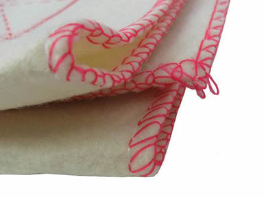 A folded natural white calligraphy writing wool felt with red overlock.