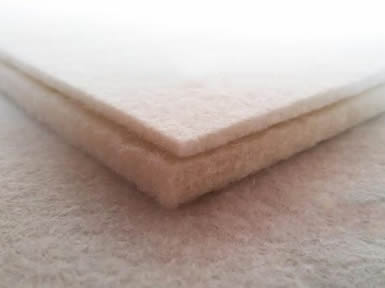 Two pieces of natural white calligraphy wool felt with different thickness.