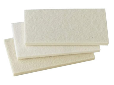 Three rectangular felt furniture pads on the white background.