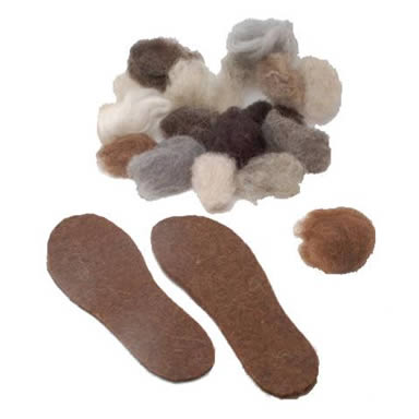 A pair of wool felt insoles and several colors of wool on the white background.