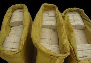 Three yellow woven bags with several pairs of wool felt insoles in it.