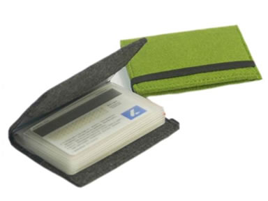A closed green card holder and an unpacked dark gray elastic band with a bank card in it.