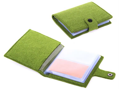 A closed green card holder and an unpacked green wool felt card holder with snap fastener.