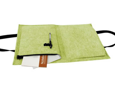 A light green folded wool felt document bag with two notebooks and a pen in it.