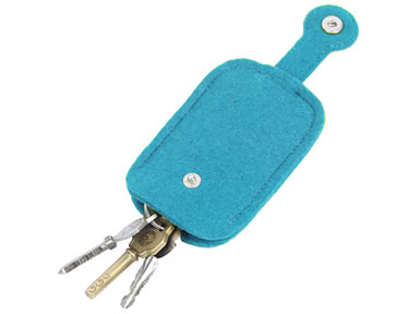 Three keys in the blue snap fastener wool felt key holder.