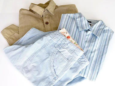 Two shirts and a pair of pants are stacked up smoothly on the white background.