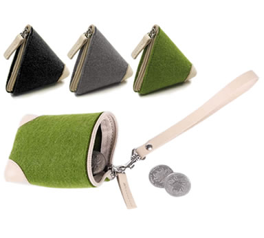 A detail structure of green zipper coin pocket with a coin in it and three different colors zipper pockets. 