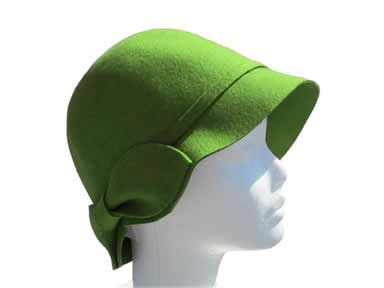 A green wool felt hat is on the head of model.