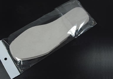 A pair of wool felt insoles in a PP bag on the black desk.